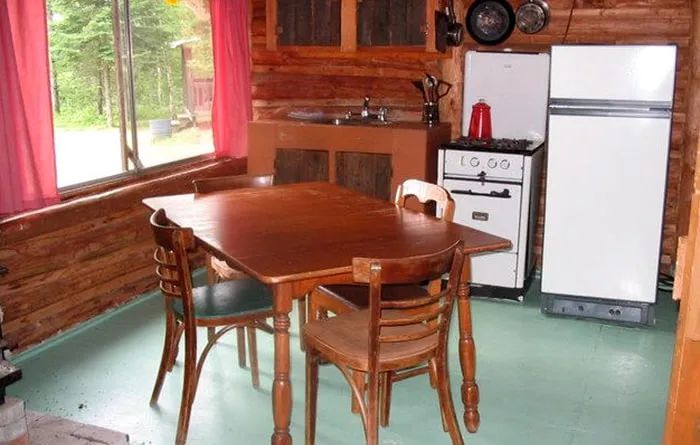 The equipped kitchen and dining area inside rustic cabin number two.