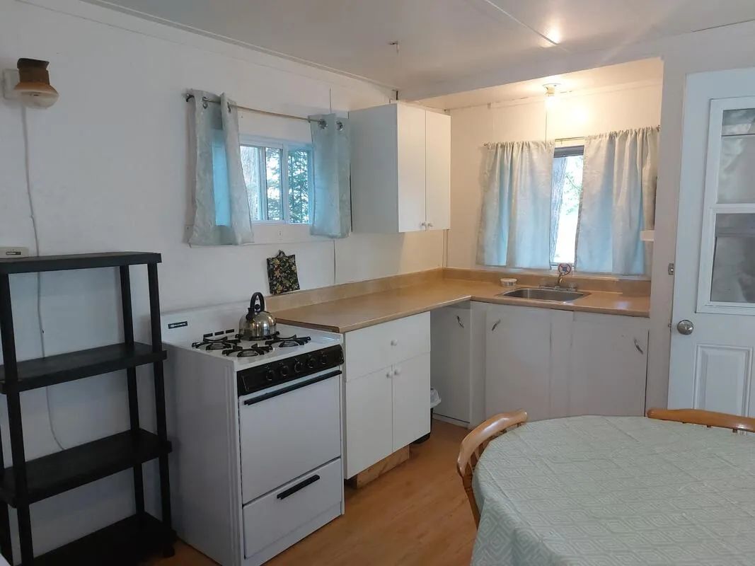 The functional kitchen of Camp 6 with stove, sink, and prep space.