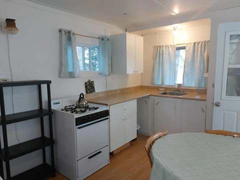 The functional kitchen of Camp 6 with stove, sink, and prep space.