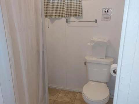 View of the functional bathroom with shower and toilet in Camp 6.