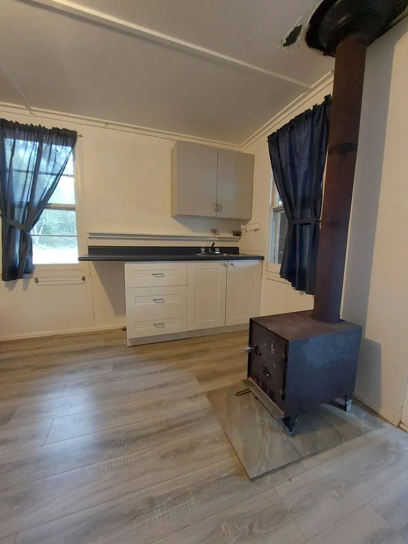View of the kitchenette and wood stove in cabin 5.