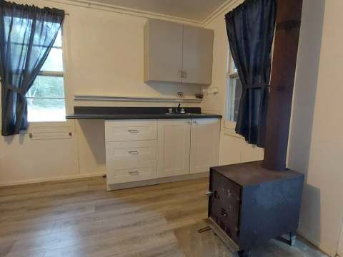 View of the kitchenette and wood stove in cabin 5.
