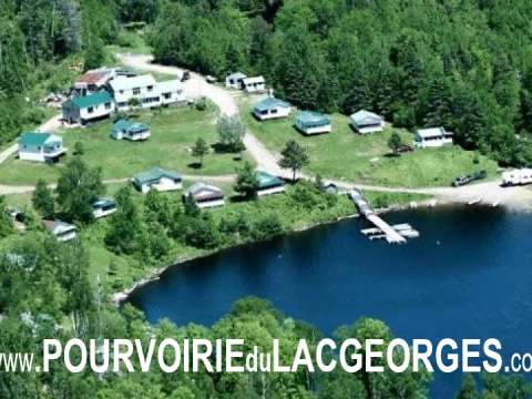 Aerial view of all the cabins and outfitter facilities by the water.