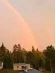 A rainbow illuminates the sky over our camping facilities.