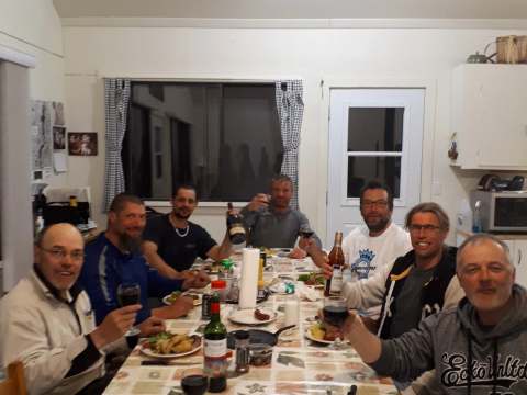 Un groupe partage un repas convivial dans la cuisine de l'un de nos chalets.