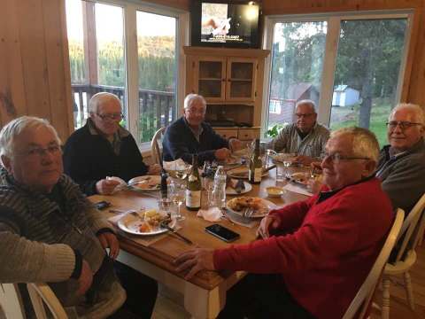 Guests share a meal in the chalet's bright dining room.