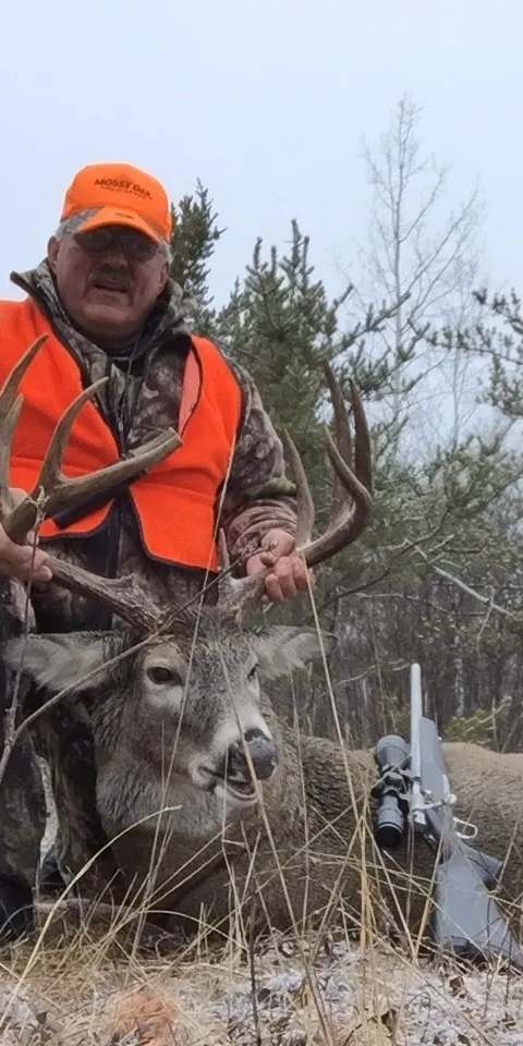 Hunter posing with a large white-tailed deer. at Harvest Lodge, Parkland, Manitoba