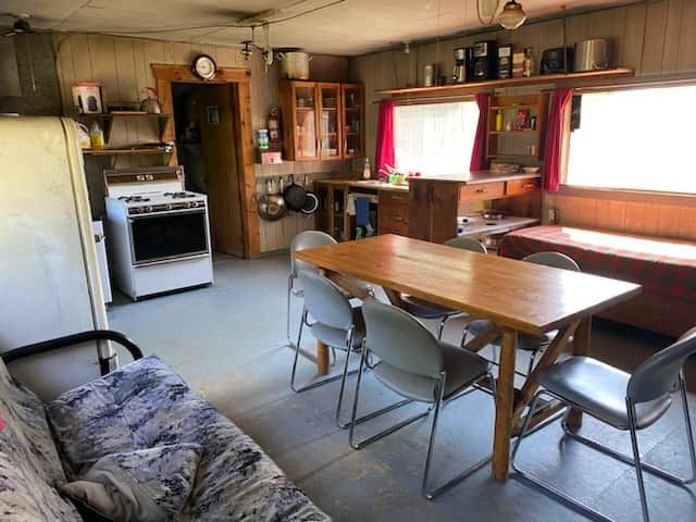 The cottage kitchen and dining area provide a practical and functional living space.