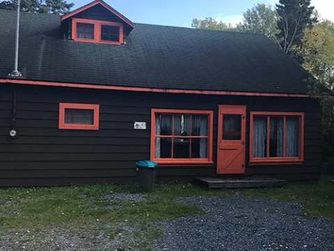 Exterior view of cabin number one with its colorful woodwork.