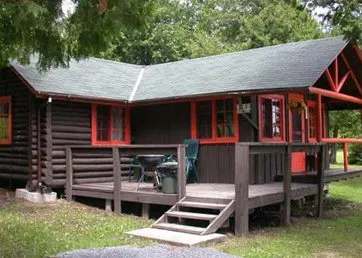 Cabin number three features a private outdoor deck surrounded by the forest.
