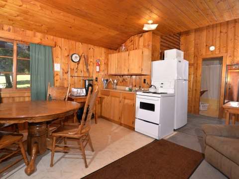 The kitchen and wooden dining area of the cabin.