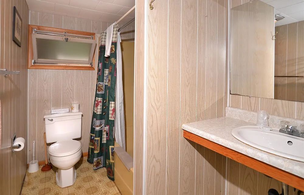 This private bathroom is equipped with a toilet, a sink, and a shower.