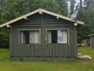 Exterior view of cabin 4 featuring its wooden siding and windows.
