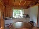 The chalet's functional kitchen includes a dining table and kitchen appliances.