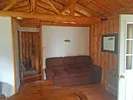 View of the cabin interior with its cozy seating area.