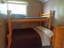 This bedroom in cabin 4 is equipped with a wooden bunk bed.