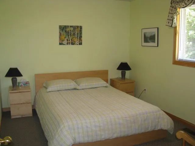 This private bedroom features a double bed with matching bedside tables.