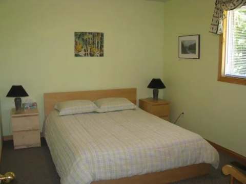 This private bedroom features a double bed with matching bedside tables.