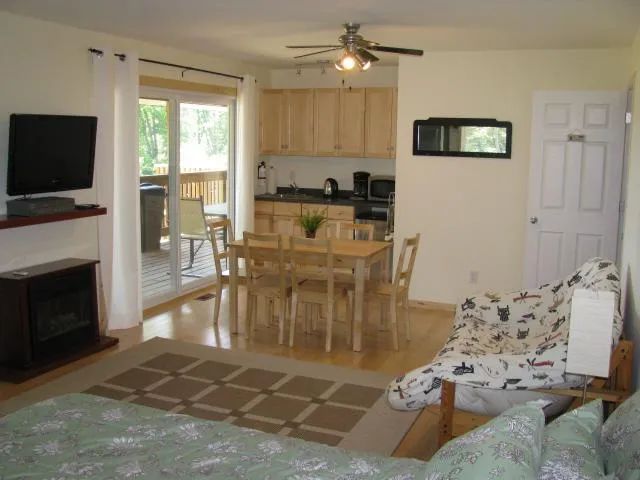 View of the open concept area featuring the kitchenette, dining table and living area of the cabin.