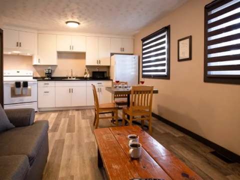 This suite features a full kitchen that opens onto a dining area and a living room.