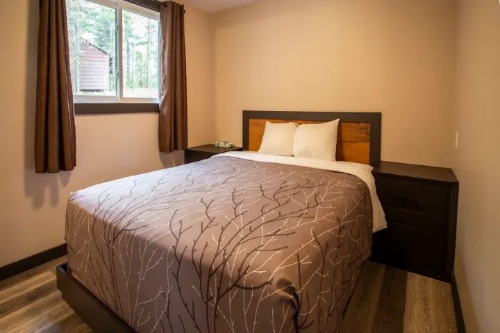 This bedroom features a comfortable double bed and matching nightstands.