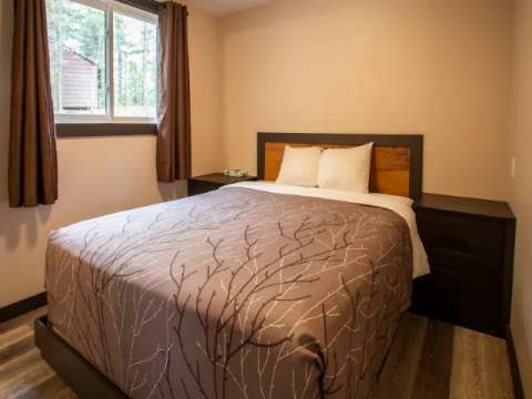 This bedroom features a comfortable double bed and matching nightstands.