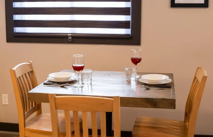 A small wooden table set for two people in the suite.