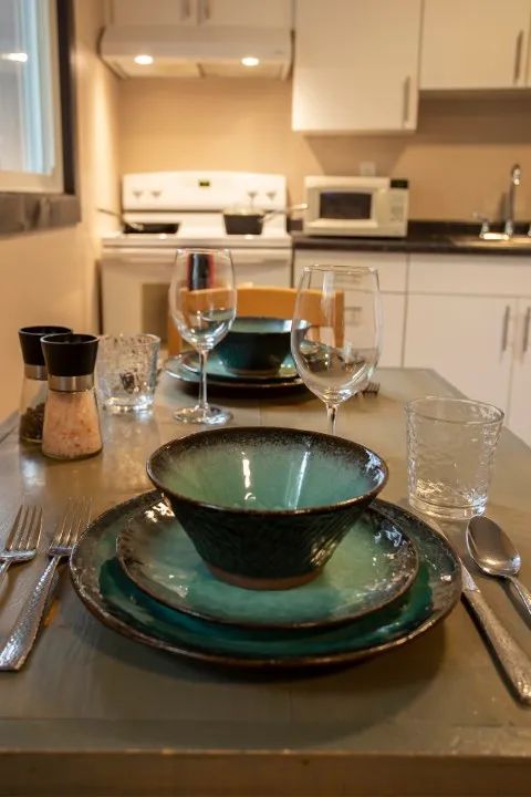 The suite's dining table is set in front of the equipped kitchen for your meals.