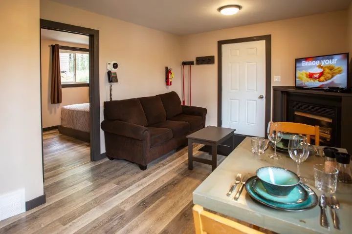 Living room and dining area of the suite, with a view into the adjacent bedroom.