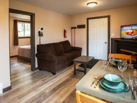 Living room and dining area of the suite, with a view into the adjacent bedroom.