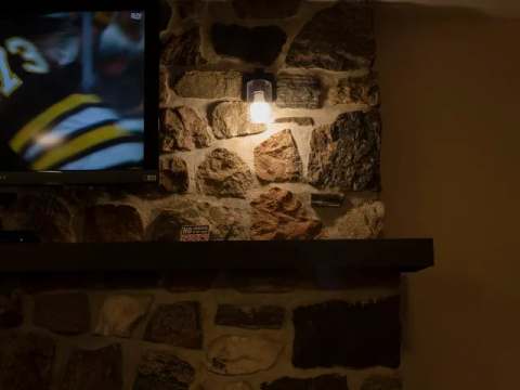 The suite's natural stone fireplace is equipped with a wall-mounted television.