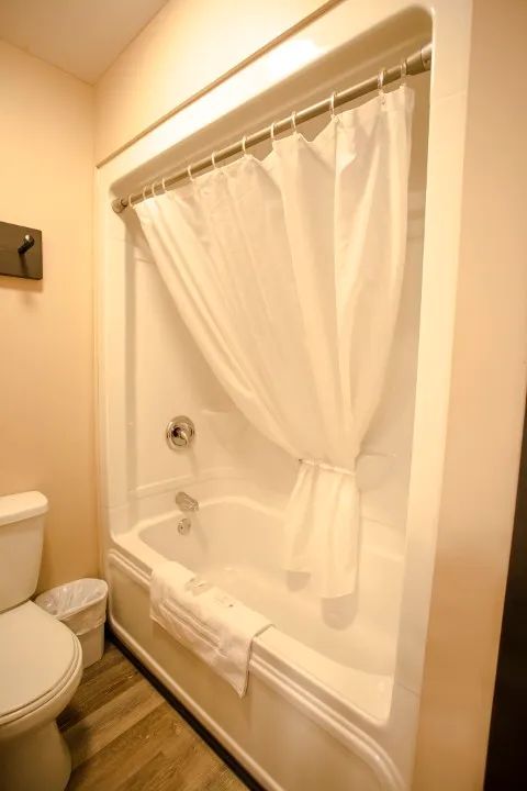 This bathroom features a bathtub and shower combination.