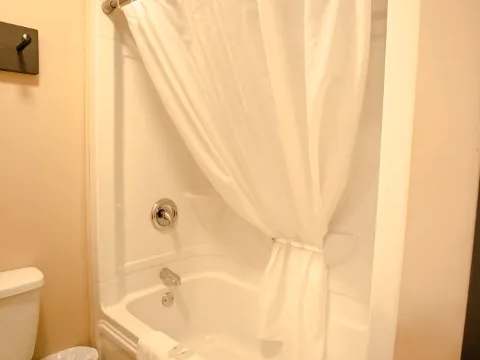 This bathroom features a bathtub and shower combination.