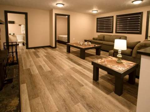 Living room of the suite with fireplace, including a sofa, coffee table, and a view of the bathroom.