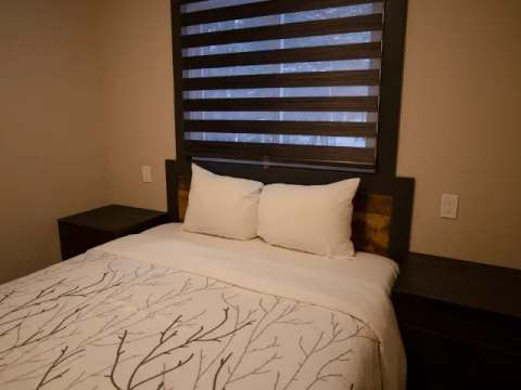 This family suite features a cozy bed with two bedside tables.