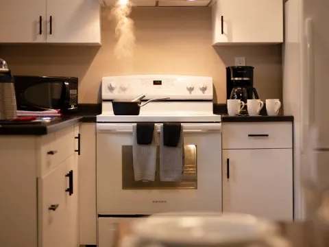The family suite's functional kitchen is equipped with a stove and modern appliances.