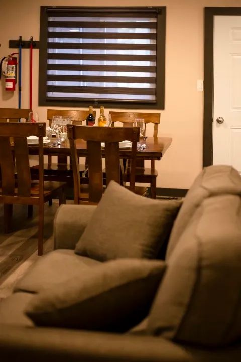 The suite offers a dining area with a wooden table adjacent to the living room.