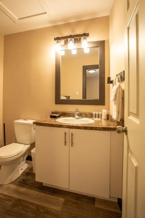 The family suite bathroom features a sink with a countertop and an illuminated mirror.