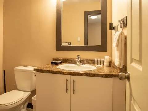 The family suite bathroom features a sink with a countertop and an illuminated mirror.