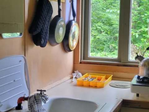 Coin cuisine fonctionnel avec évier et ustensiles dans le camp Villa-Dama.
