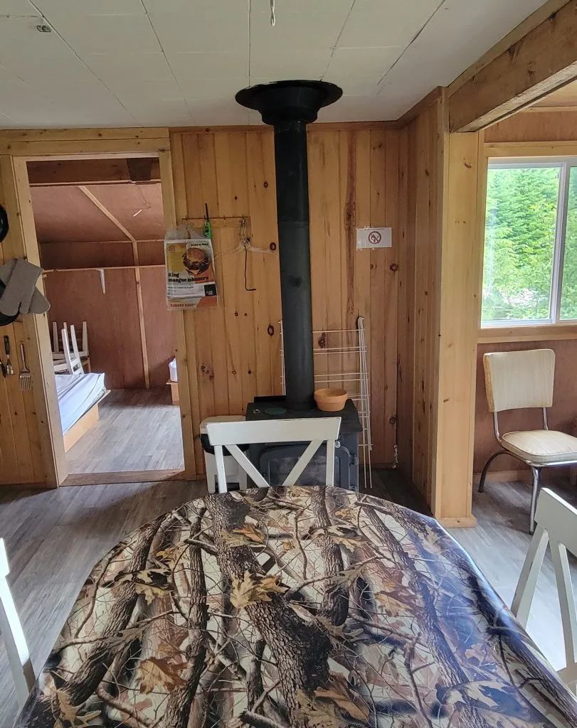 View of the dining area and wood stove in the Ducharme cottage.