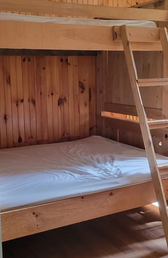 The cottage bedrooms are equipped with wooden bunk beds.