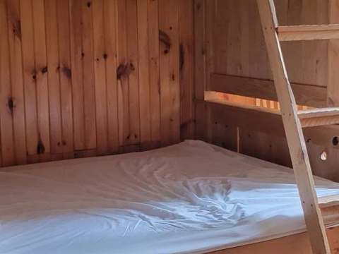 The cottage bedrooms are equipped with wooden bunk beds.
