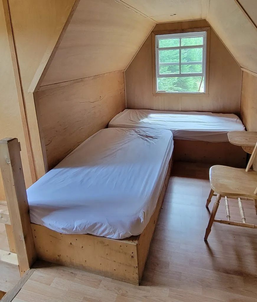 This bedroom in the attic of the Troll chalet features two single beds.