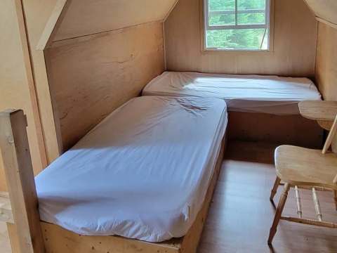 This bedroom in the attic of the Troll chalet features two single beds.
