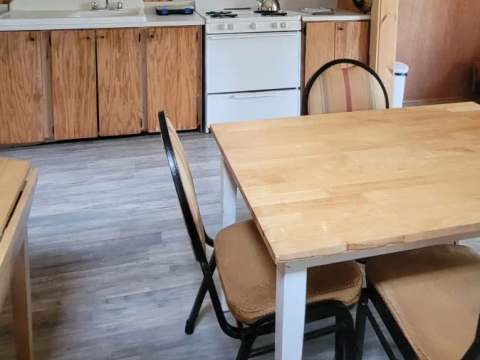 The functional kitchen of the Troll cottage includes a dining table and necessary equipment.