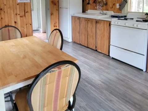 The functional kitchen of the Troll cottage includes a dining table and home appliances.