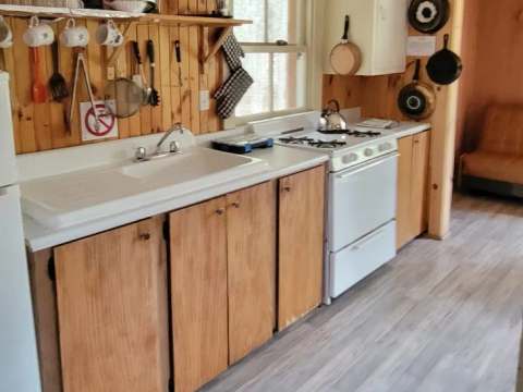 The functional kitchen of the Troll chalet includes a stove and a convenient sink.