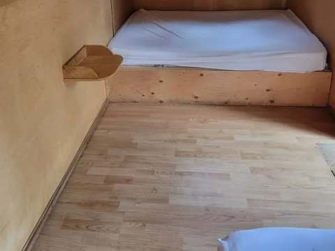 The bedroom under the eaves of the Troll cabin provides a sleeping area with two beds.