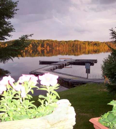 Dock and flowers by the water at Perch Lake Lodge, Sunset Country, Ontario